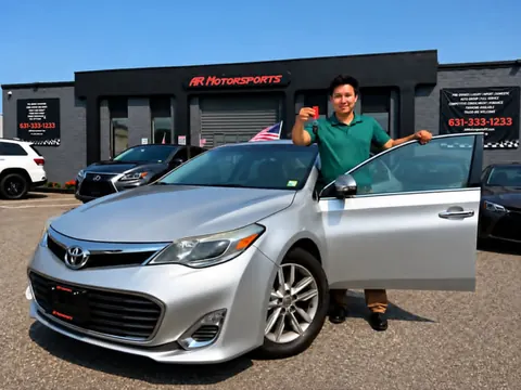 Customer with a used car at AR Motorsports in Bay Shore, NY